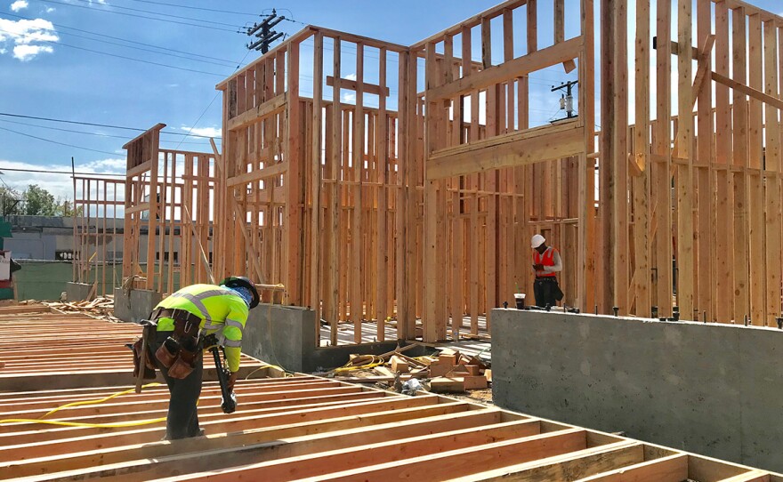 Construction crews work on a 24-unit apartment building in North Park, July 23, 2019.