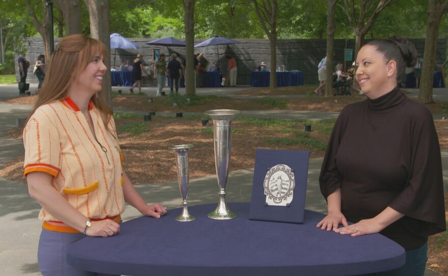 Laura Woolley (left) appraises 1921 and 1923 Miss America Pageant trophies, in Raleigh, NC. ANTIQUES ROADSHOW “North Carolina Museum of Art, Hour 2” premieres Monday, April 15 at 8/7C PM on PBS