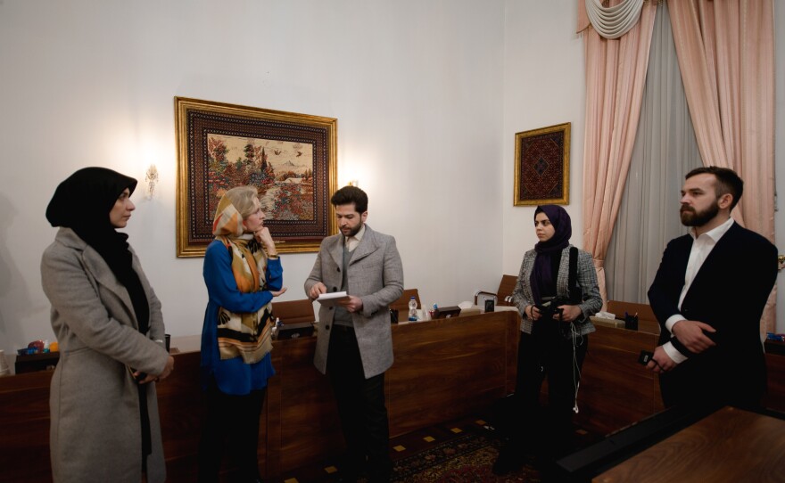 The NPR team — Mary Louise Kelly (second from left), and (right) Fatma Tanis and Connor Donevan — prepare for the interview.