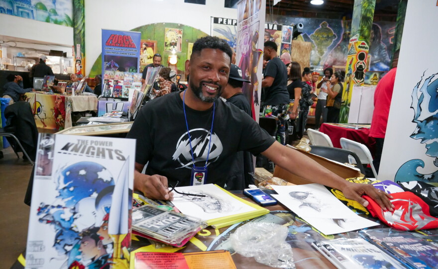 Black Comix Day founder Keithan Jones at his table to promote his comic "The Power Knights" and his company KID Comics. Feb. 2022