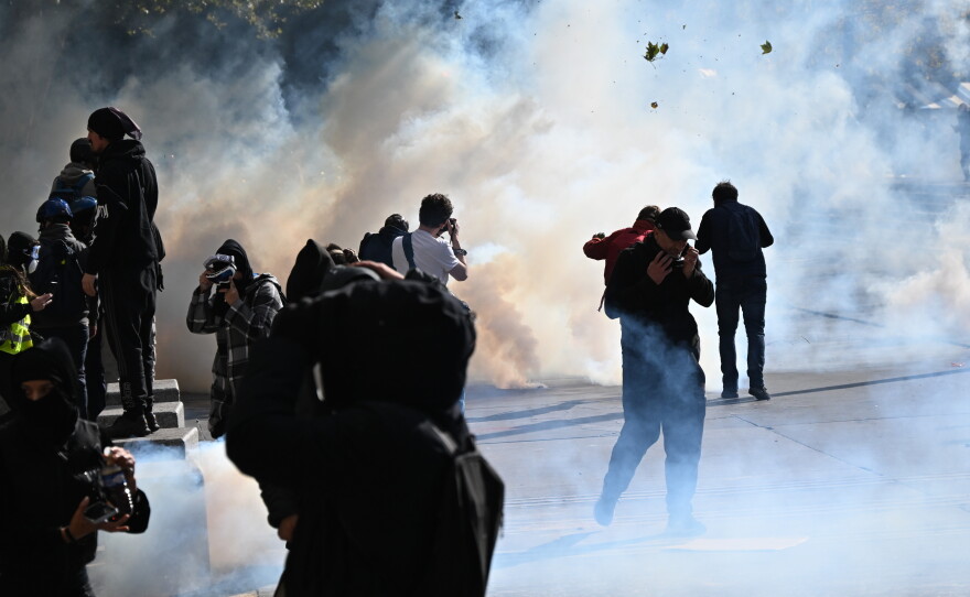 Protesters scuffle with police during a demonstration against rising living costs, joining students' grievances, in Paris on Saturday.