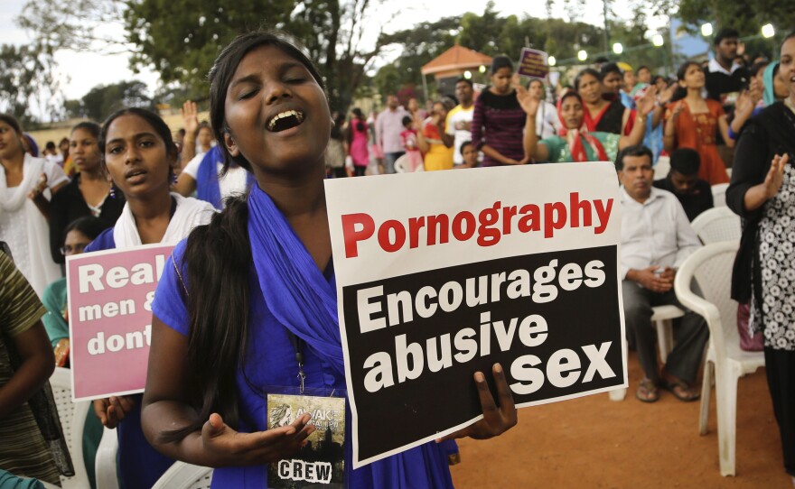 An Indian Christian woman holds a placard denouncing pornography at a protest rally in Bangalore, in August 2014.