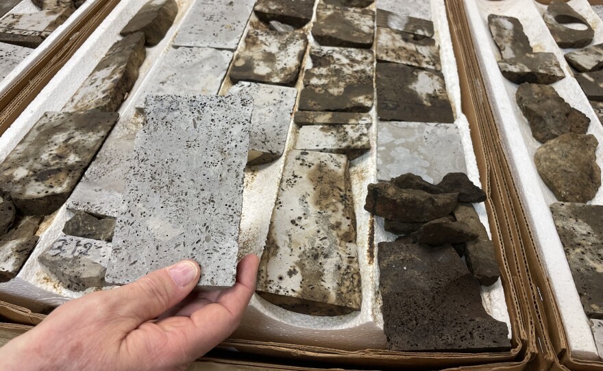 Geologist Bob Trentham holds up a core sample in his lab in Odessa, Texas. These samples came from a rock formation that had already had oil extracted from it. The section he's holding has been cleaned; behind it, you can see the samples that are still stained with oil that was trapped in the rock and could not reach the well.