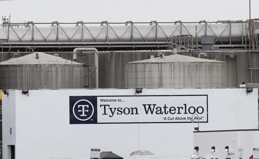 Vehicles sit in a near empty parking lot outside the Tyson Foods plant in Waterloo, Iowa, on May 1.