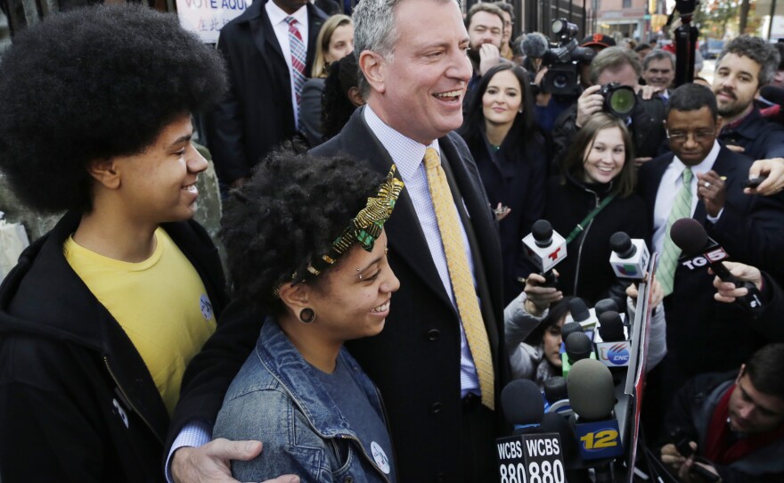 Democratic mayoral candidate Bill de Blasio with his daughter Chiara and son Dante as he talks to the media in Brooklyn after voting, Tuesday, Nov. 5, 2013.