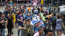 Crowds of people cross the street to enter the convention center at San Diego International Comic-Con, July 9, 2015. 