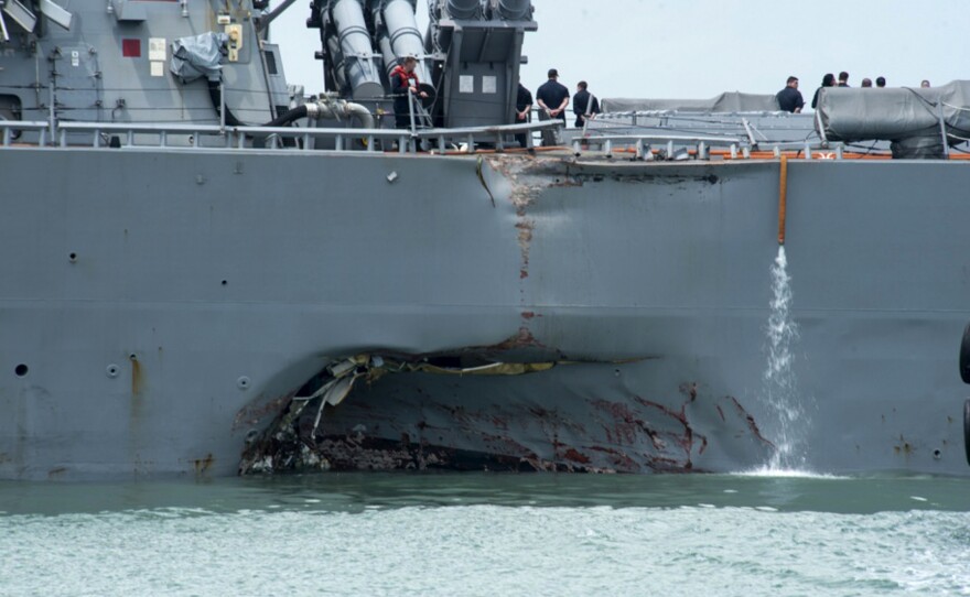 Damage to the port side is visible as the guided-missile destroyer USS John S. McCain steers toward Changi naval base in Singapore following a collision with the merchant vessel Alnic MC on Monday.