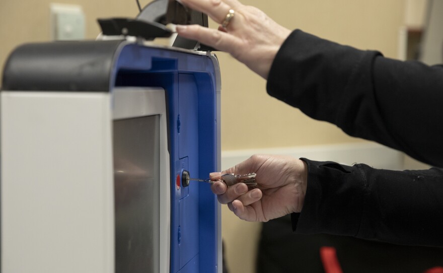 Lisa Bosch, of Wright Township, assembles a ballot reading machine during a poll worker training.