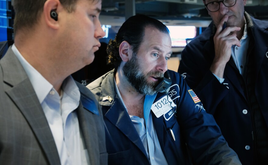 Traders work on the floor of the New York Stock Exchange (NYSE) in New York City on Thursday. Fears about the Fed's aggressive actions against inflation have raised concerns about the impact on the economy.
