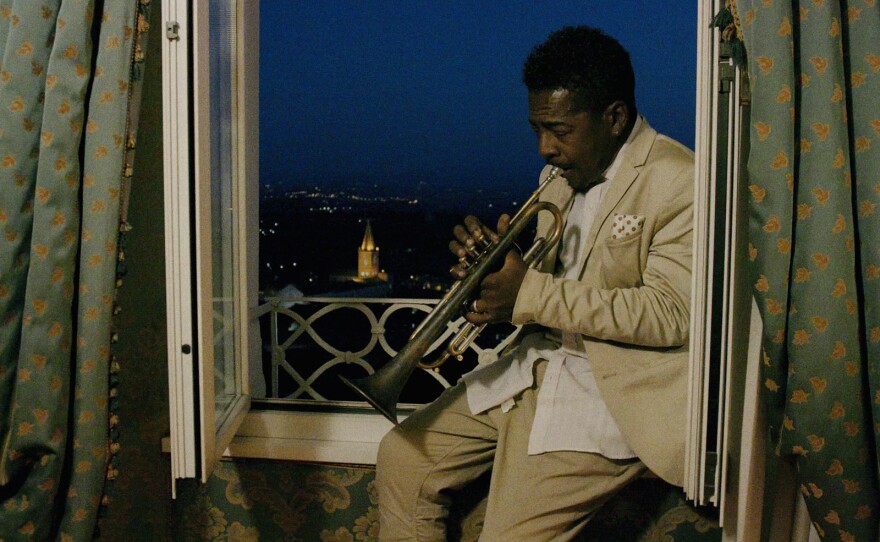 Roy Hargrove plays the trumpet sitting near windowsill in Perugia, Umbria in central Italy (undated)