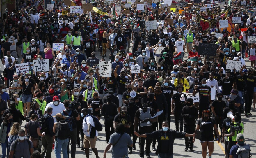 Protesters march in a Black Lives Matter march for Jacob Blake in Kenosha, WI.