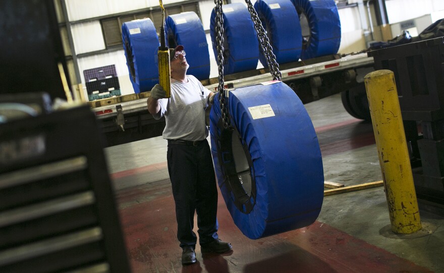 Darren Holly steers coils of steel through Pentaflex, a manufacturer of parts for heavy trucks, in Springfield, Ohio.