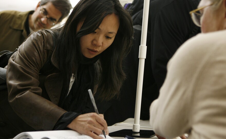 Tanya Lau signs in to vote at the Chinese Community Church in Washington in 2010. Voter turnout has been low among Asian-Americans in recent elections, but a new superPAC hopes to increase it.
