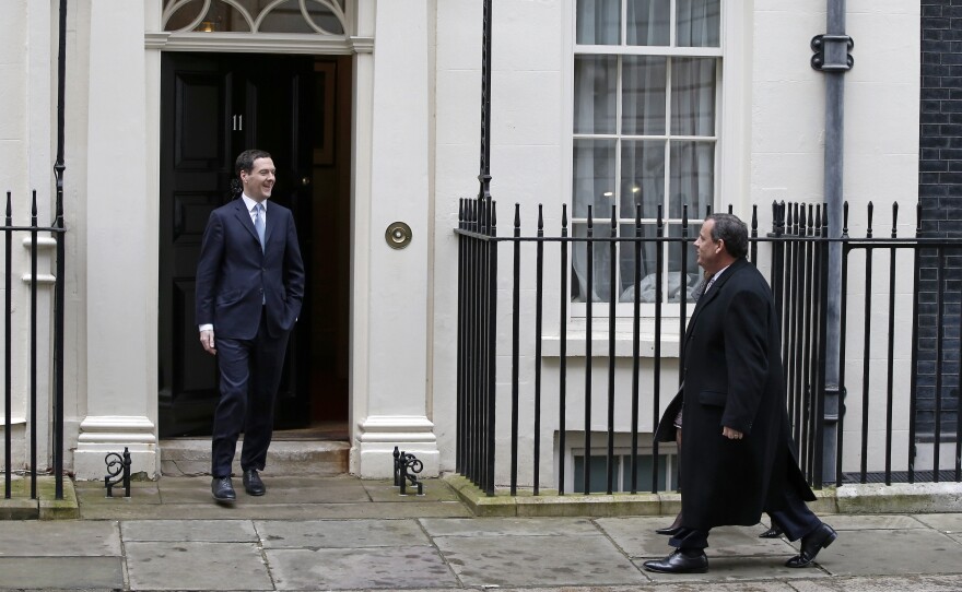 Britain's Finance Minister George Osborne greets New Jersey Gov. Chris Christie outside 11 Downing Street in London. Christie had a bumpy trip after he said parents should "have some measure of choice" when it comes to vaccinating their children.