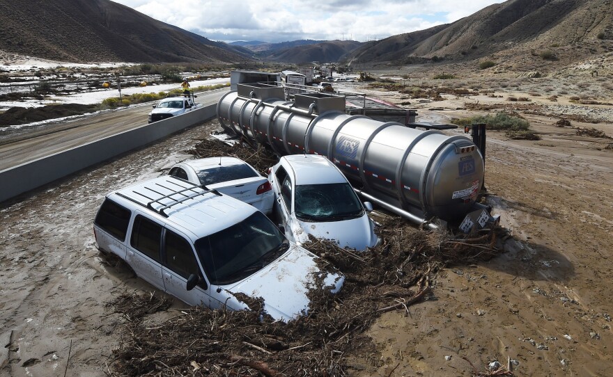 Vehicles are stuck on a road after being trapped by a mudslide on California Highway 58 in Mojave, California on Friday.