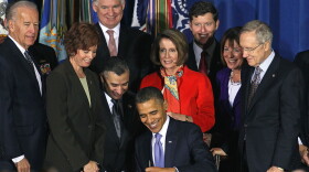 U.S. President Barack Obama (C) signs legislation repealing military policy law during a ceremony December 22, 2010 in Washington, DC. President Obama signed into law a bill repealing the 'don't ask, don't tell' law against gays serving openly in the military.
