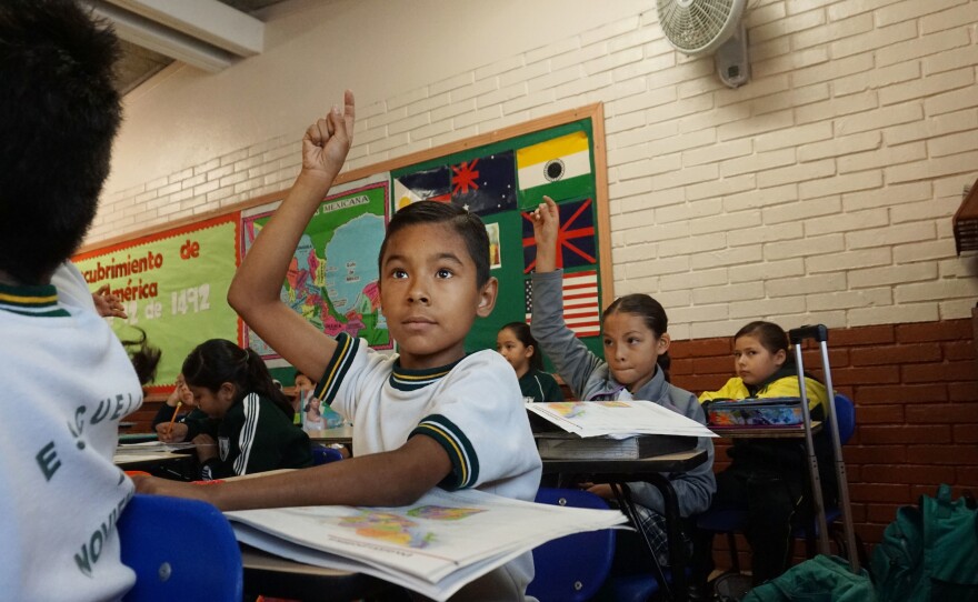 Anthony David Martinez raises his hand in class at the Escuela 20 Noviembre school in Tijuana, Mexico.