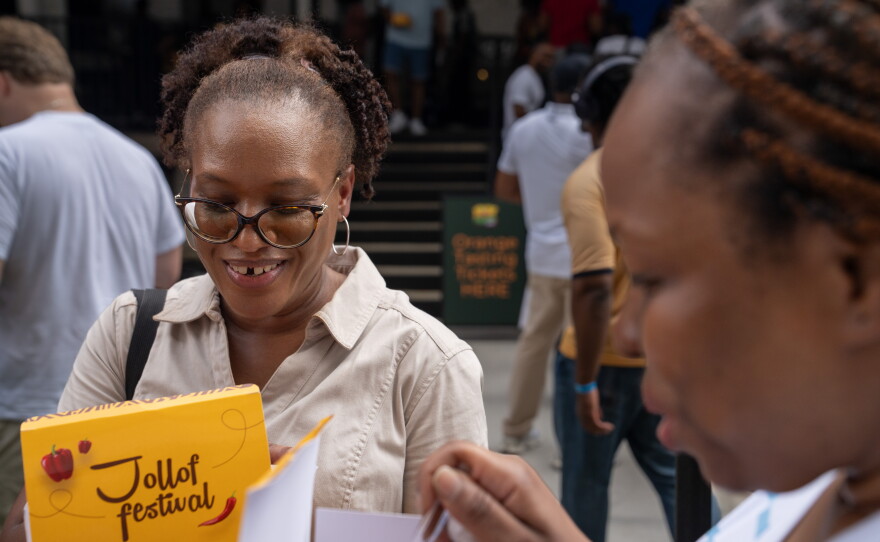 Shakesha Coleman (left) and Julie Agbasi, try some of the samples of jollof rice at the festival.