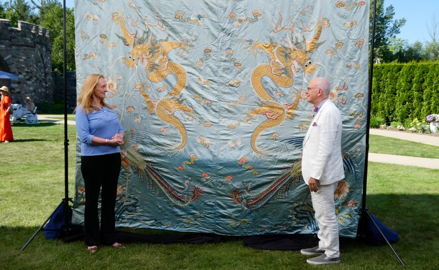 Lark E. Mason (right) appraises a Chinese imperial silk panel, ca. 1900 in Charlevoix, Mich. ANTIQUES ROADSHOW “Castle Farms, Hour 2” premieres Monday, April 6 at 8/7C PM on PBS.