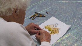 A client with Alzheimer’s disease works on her coloring at Casa Pacifica Adult Day Health Care Center in this undated photo.