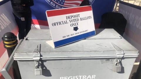 A ballot box is watched by two attendants at the San Diego Registrar of Voters, March 11, 2022.