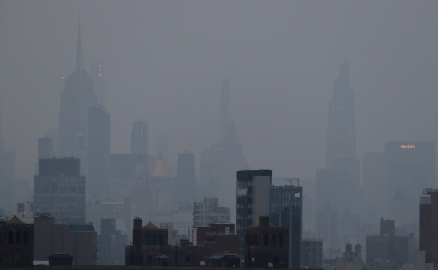 A thick haze hangs over Manhattan on Tuesday. Wildfires in the West, including the Bootleg Fire in Oregon, are creating hazy skies and poor air quality as far away as the East Coast.