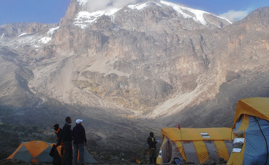 Hikers stand by tents along a trekking route on Mount Kilimanjaro in 2014. The Tanzanian government has installed high-speed internet service on the slopes of the mountain.