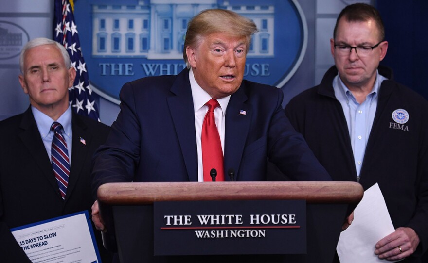 President Trump, flanked by FEMA Administrator Peter Gaynor, right, and Vice President Mike Pence, speaks during a daily briefing on the coronavirus.