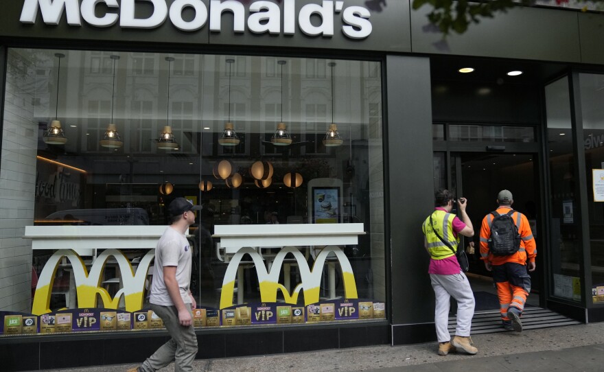 Customers walks into a McDonald's restaurant, in London on Aug. 24. McDonald's says it has pulled milkshakes from the menu in all 1,250 of its British restaurants because of supply problems stemming from a shortage of truck drivers.