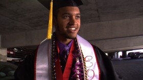 Anthony Porter, 24, finishes putting on his graduation robe, mortarboard and honors cords in the parking lot just before commencement, May 21, 2011