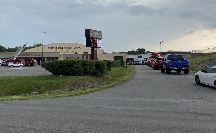 Seniors line up in cars with their families in the main drive of Webster County High School in Dixon, Ky., waiting to pick up their diplomas outside of the school one at a time. Like almost all schools across the U.S., county high school officials had to adapt this year's graduation ceremony because of the COVID-19 pandemic.