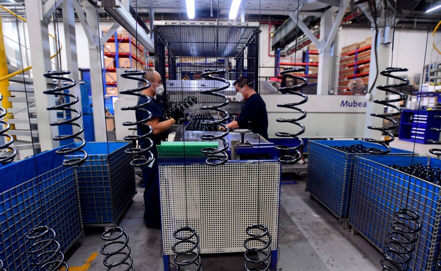 Employees work on automobile parts at a production line at the BMW factory in Shenyang, China, on Nov. 22. Twelve percent of workers in China could need to switch jobs by 2030, researchers say.