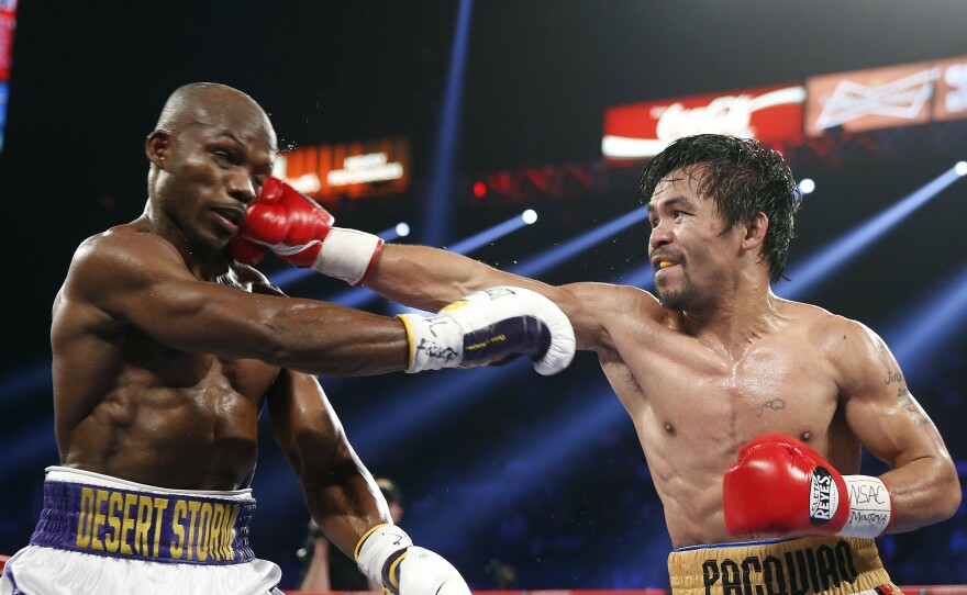 Manny Pacquiao (right), of the Philippines, hits Timothy Bradley Jr. during their WBO welterweight title boxing bout on Saturday in Las Vegas.