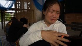Liu Fengling comforts her daughter and son in Bangkok after spending four months in detention.