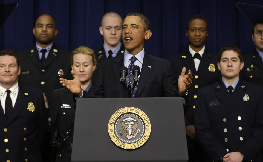 President Obama, accompanied by emergency responders, a group of workers the White House says could be affected if state and local governments lose federal money as a result of budget cuts, speaks in the Eisenhower Executive Office building in Washington on Tuesday.