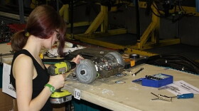 A student works on her robot gladiator.