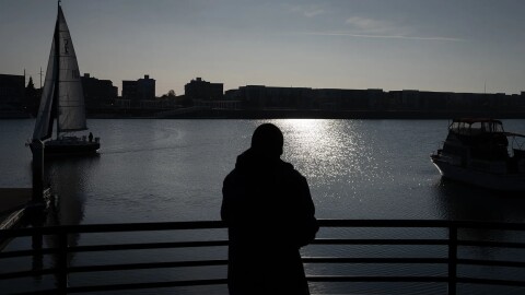 J.M., who prefers to use his initials for privacy, looks out at the San Francisco Bay at Jack London Square, where he walks almost daily for exercise and because he enjoys looking at the water, in Oakland on Dec. 1, 2025. JM received housing support through CARE Court and now lives within walking distance of Jack London.