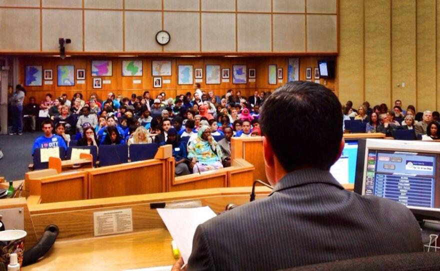 City Council President Todd Gloria looks out at the people filling the San Diego City Council chambers for the public hearing on the Fiscal Year 2014 budget.