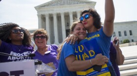 Bethany Van Kampen, left, hugs Alejandra Pablus as they celebrate during a rally at the Supreme Court in Washington, June 27, 2016.