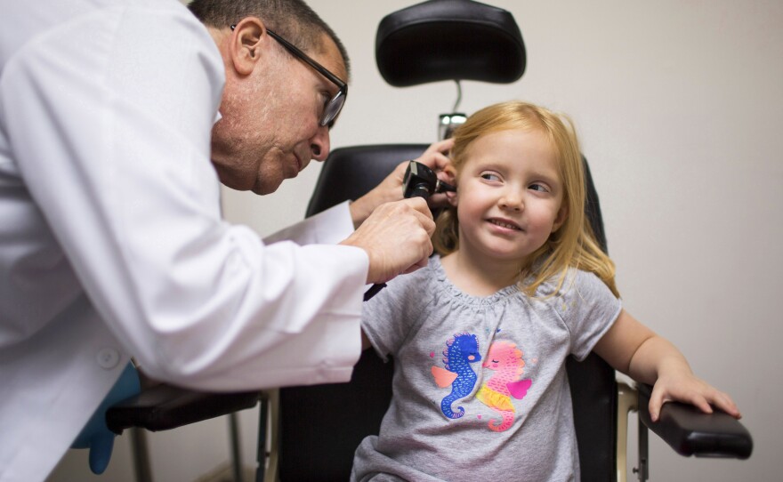 Dr. Max Lebow examines the ear of 4-year-old Charlotte Anderson at Reliant Immediate Care in Los Angeles. Charlotte's mom brought her to the urgent care clinic because Charlotte was having balance problems.