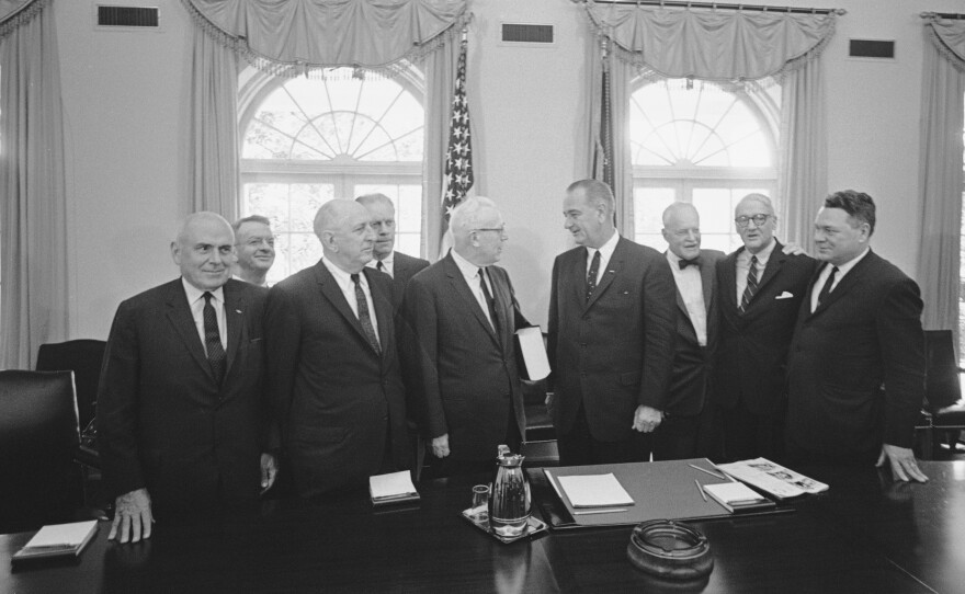 The Warren Commission delivers its report on Kennedy's assassination to President Lyndon B. Johnson in the Cabinet Room of the White House on Sept. 24, 1964. From left: lawyer John McCloy, General Counsel J. Lee Rankin, Sen. Richard Russell, Rep. Gerald Ford, Chief Justice Earl Warren, President Johnson, former CIA Director Allen Dulles, Sen. John Sherman Cooper, and Rep. Hale Boggs.