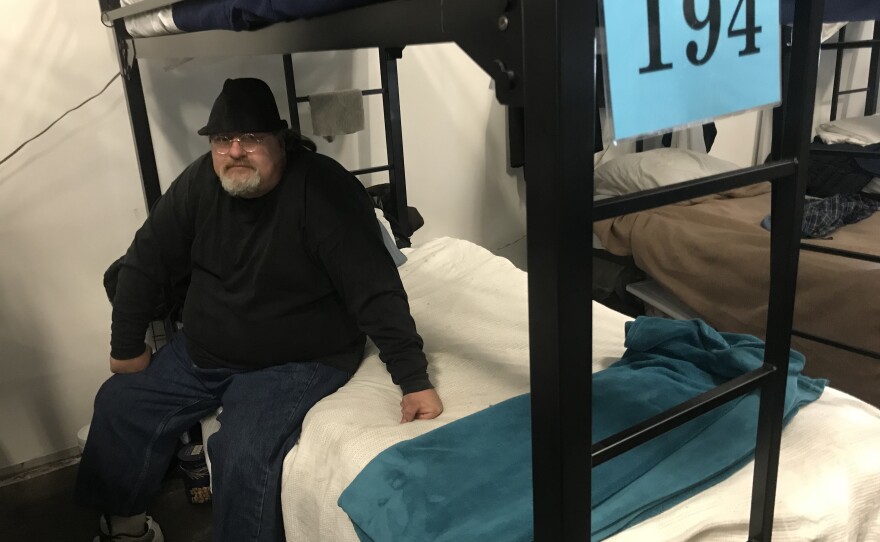Joseph Lemaster, 49, sits on his assigned bed in a homeless tent shelter near downtown San Diego, Feb. 21, 2018.