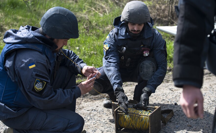 Kharkiv EOD technicians wire the blasting cap to the firing line in preparation for detonating the first mines.