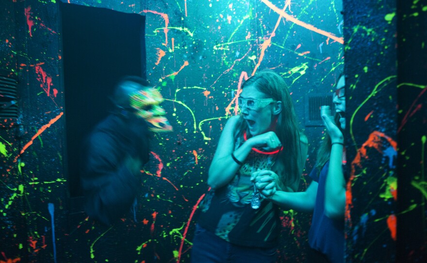 Taylor Vankooten (center) and Christina DuPree scream as an actor jumps out at them in 3-D. Vankooten and DuPree both work at the Halloween Haunt at Dorney Park in Allentown, Pa.