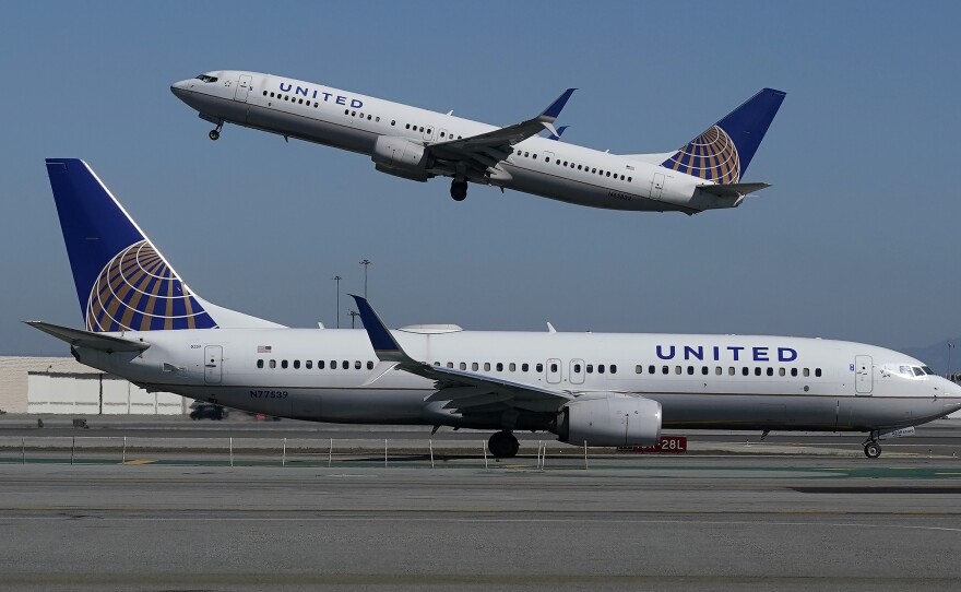 A United Airlines airplane takes off over another plane on the runway at San Francisco International Airport in San Francisco on Oct. 15, 2020. United announced a new order of 270 narrow-bodied planes from Boeing and Airbus.