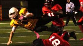 Cpl. Wiley Flowers, a defensive back with the Marine Corps Air Station Miramar Falcons, takes down a player with the 1st Marine Logistics Group Beast during a Camp Pendleton Football League Championship playoff game against the 1st MLG Beast at the Paige Field House Football Field aboard Marine Corps Base Camp Pendleton.