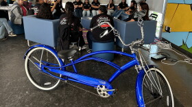 Mentors with the United Lowrider Youth Leadership Bike Club speak to students in the program on April, 28, 2026.