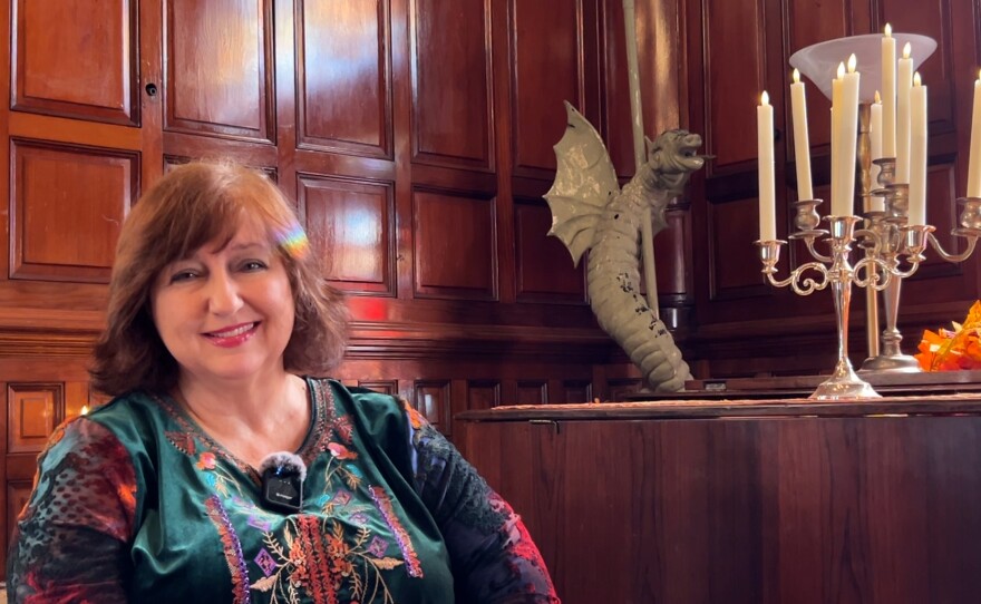 Louise Torio, president of the Friends of Villa Montezuma, Inc., sitting by one of the rooftop gargoyles that is waiting to be restored. Oct. 10, 2015