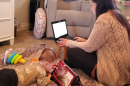 Ariana Steck works on her laptop while caring for her six-month-old son Griffin in their North Park apartment, May 11, 2022.