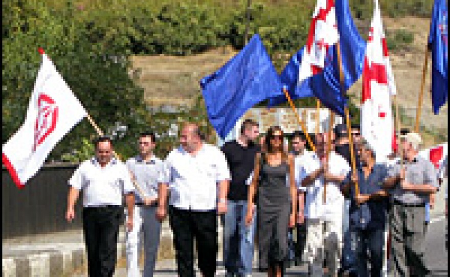 Members of a Georgian labor union march up to a Russian military checkpoint to demand the end of Russia's occupation of Georgian territory.